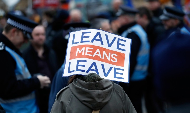 A pro-leave supporter carries a placard during demonstrations in London, Tuesday, Jan. 29, 2019. (AP Photo)