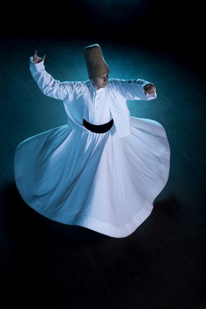 A whirling dervish spins from left to right as a symbol of his gratitude to his creator.