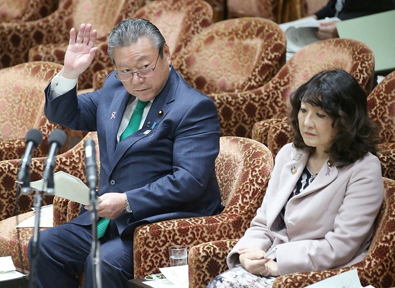 This Nov. 14, 2018 photo shows Yoshitaka Sakurada (L) raising his hand to answer a question beside Satsuki Katayama (R), minister in charge of regional revitalization and female empowerment, during a parliament session in Tokyo. (AFP Photo)