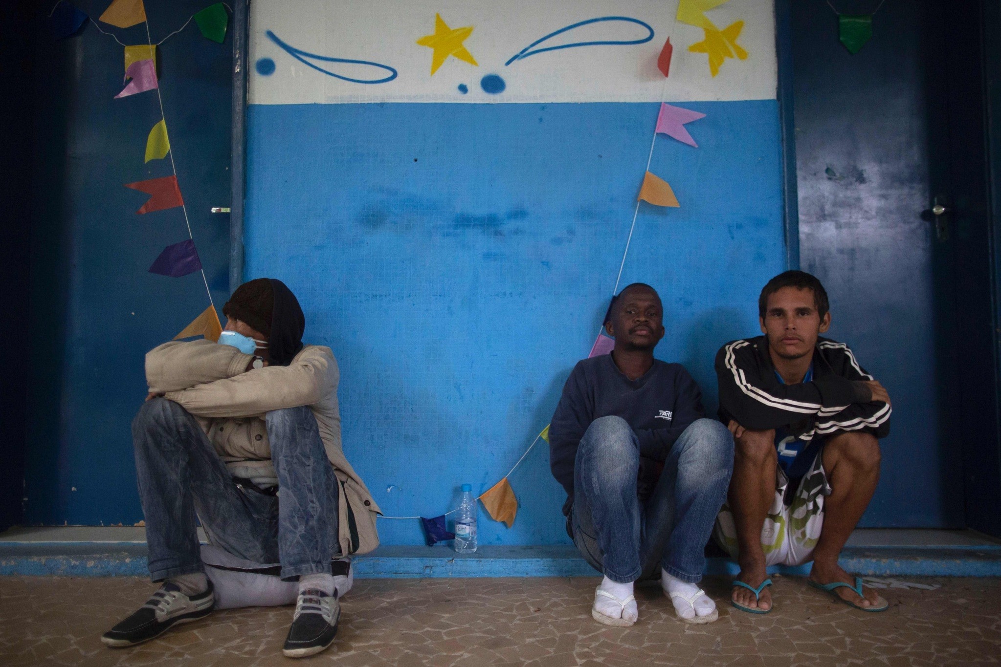 People wait to get inside a public shelter for the homeless in the Ilha do Governador neighborhood of Rio de Janeiro.