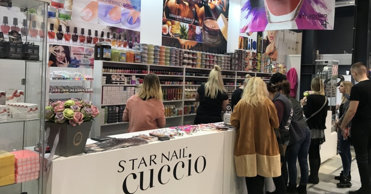 People examine cosmetics on the sidelines of Beauty Forum in Warsaw, March 9, 2019.