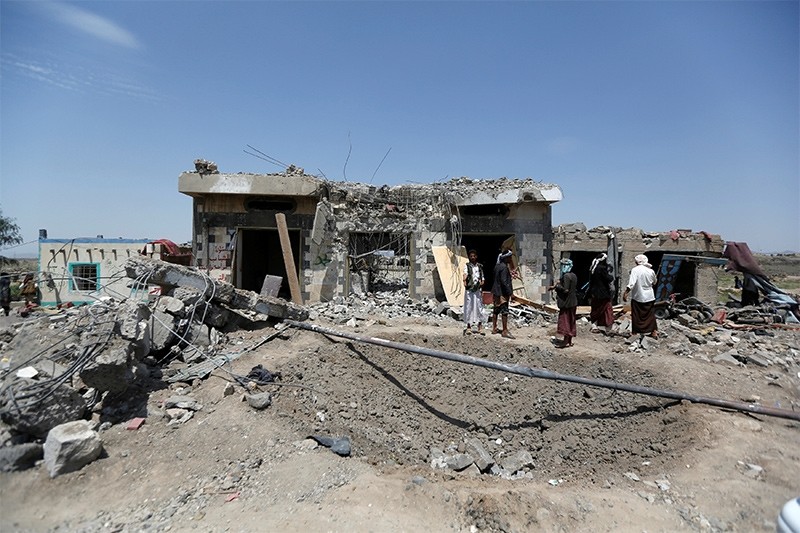 People stand at the site of Saudi-led air strikes in Arhab area, around 20 kilometres (13 miles) north of Sanaa, Yemen August 23, 2017 (Reuters Photo)