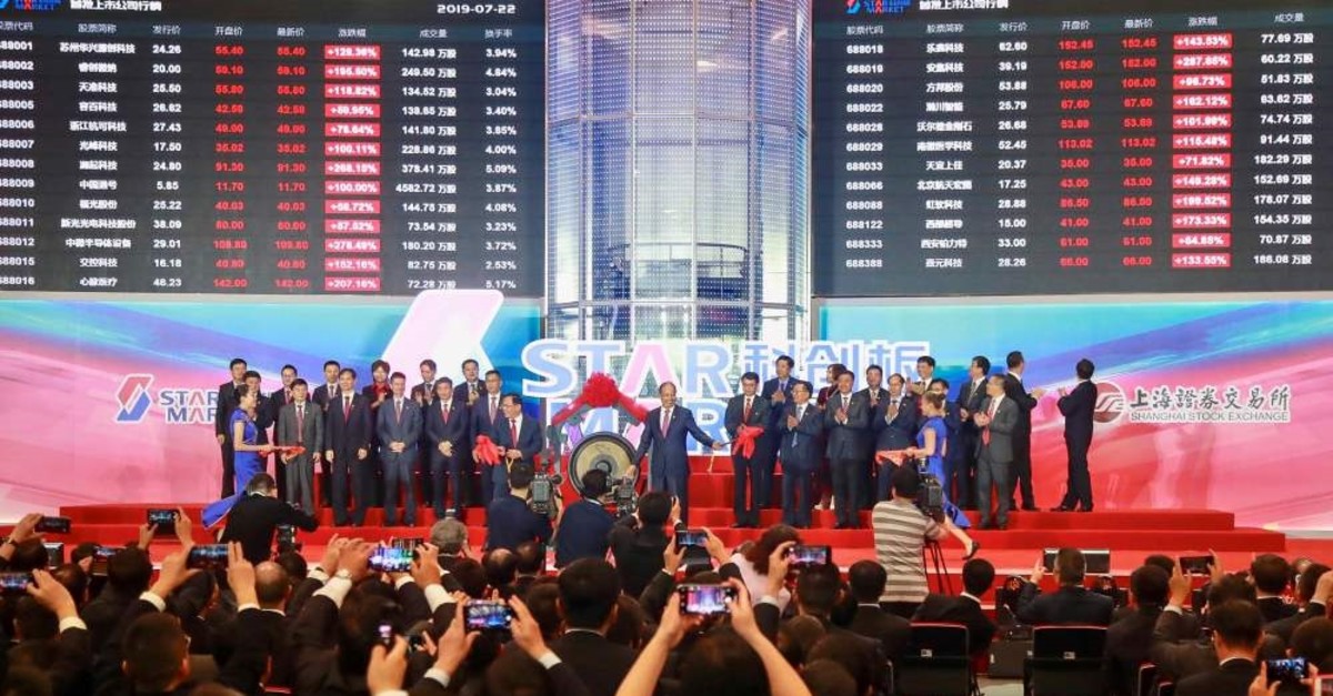People take pictures during an opening ceremony of the Shanghai Stock Exchange's Sci-Tech Innovation Board, Shanghai, July 22, 2019.