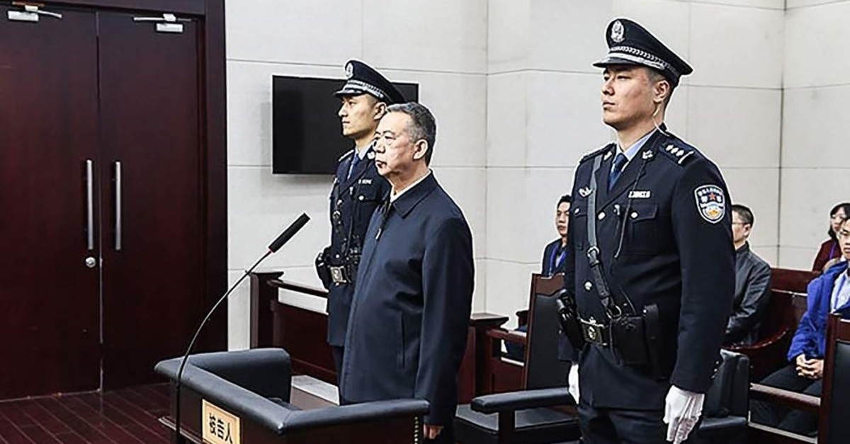 This Jan. 21, 2020, handout photo released by the Tianjin First Intermediate People's Court shows former Interpol chief Meng Hongwei (C) during his sentencing at a court in Tianjin, China. (AFP Photo/Tianjin First Intermediate People's Court)