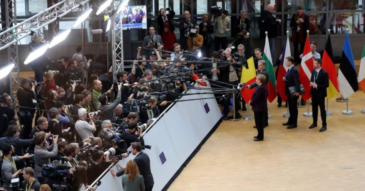 Germany's Chancellor Angela Merkel (R) and Luxembourg's Prime Minister Xavier Bettel (L) answer journalists' questions as they arrive for a special European Council summit, Brussels, Feb. 20, 2020, held to discuss the next long-term budget of the EU. (AFP Photo)