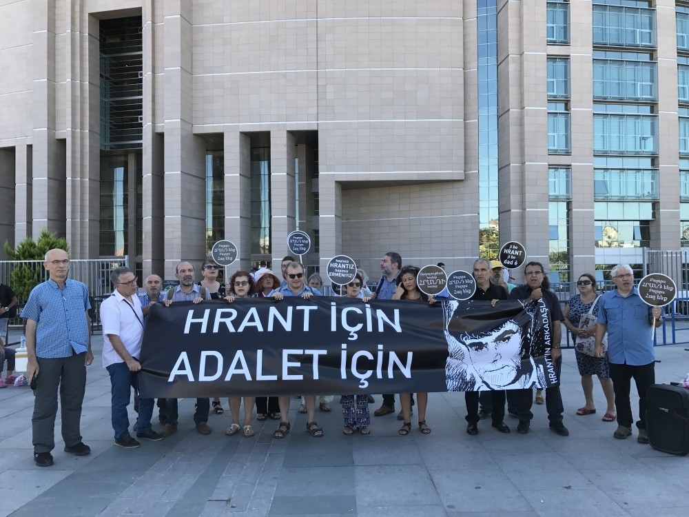 Activists carry a photo of Hrant Dink with a banner reading ,For Hrant, For Justice.,