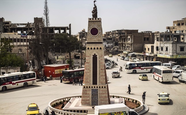 People walk in a square in the northern Syrian city of Raqqa, the former Syrian capital of Daesh, on April 14, 2019.