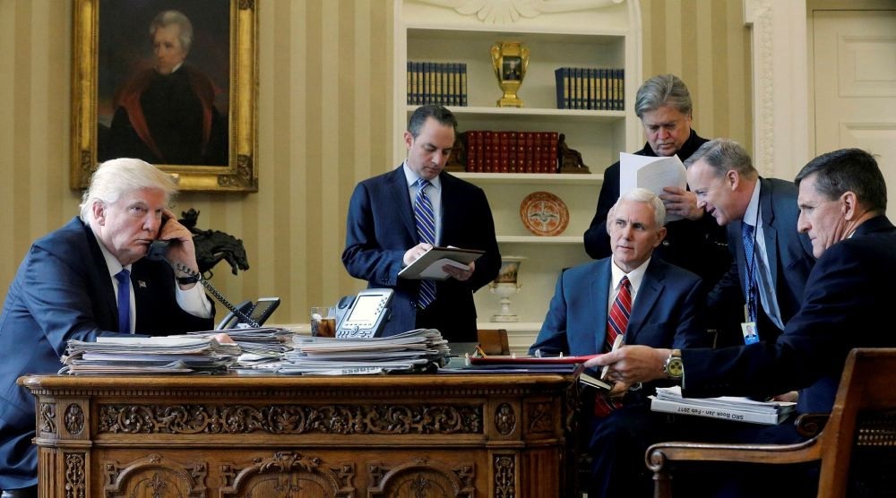 Trump joined by (from left to right) Chief of Staff Priebus, VP Pence, senior advisor Bannon, Communications Director Spicer and National Security Advisor Flynn, speaks by phone with Russia's Putin in the Oval Office at the White House