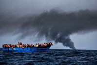 Migrants wait to be rescued by Italian authorities as they drift in the Mediterranean Sea some 20 nautical miles north off the coast of Libya, October 3, 2016.