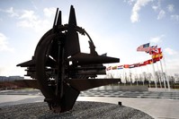 Flags seen behind the iconic NATO symbol at NATO headquarters in Brussels, Belgium, Feb. 2, 2020. (AA Photo)