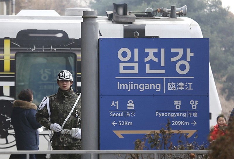  In this Jan. 14, 2018, file photo, a South Korean army soldier stands guard next to a signboard showing the distance to North Korea's capital Pyongyang and to South Korea's capital Seoul (AP Photo)