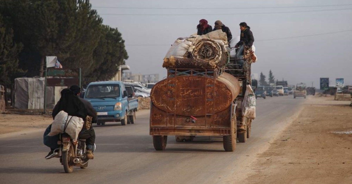 People flee from the south of Idlib amidst an ongoing regime forces' offensive, driving through the town of Hazano in the northern countryside of Syria's Idlib province, Jan. 27, 2020. (Photo by AAREF WATAD / AFP)