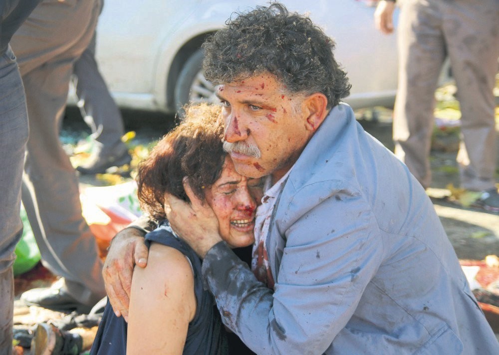 An injured man comforts an injured woman after the suicide attack during a rally in Ankara, Oct. 10, 2015, the deadliest terrorist attack in Turkey's history. 
