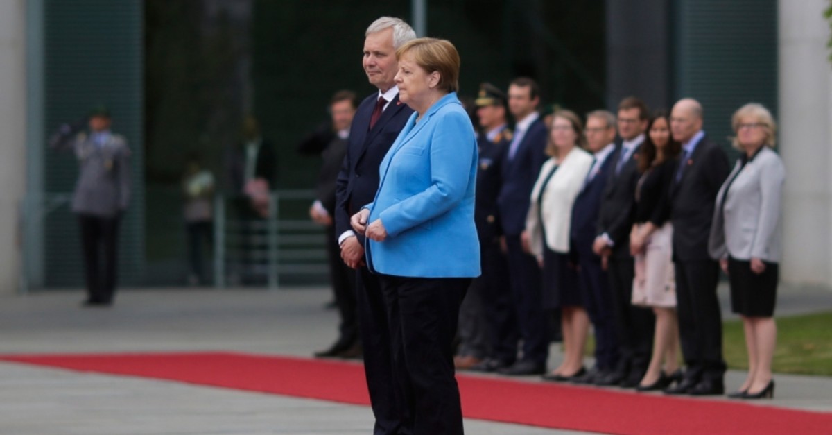 German Chancellor Angela Merkel and Prime Minister of Finland Antti Rinne listen to the national anthems at the chancellery in Berlin, Germany, Wednesday, July 10, 2019. (AP Photo)