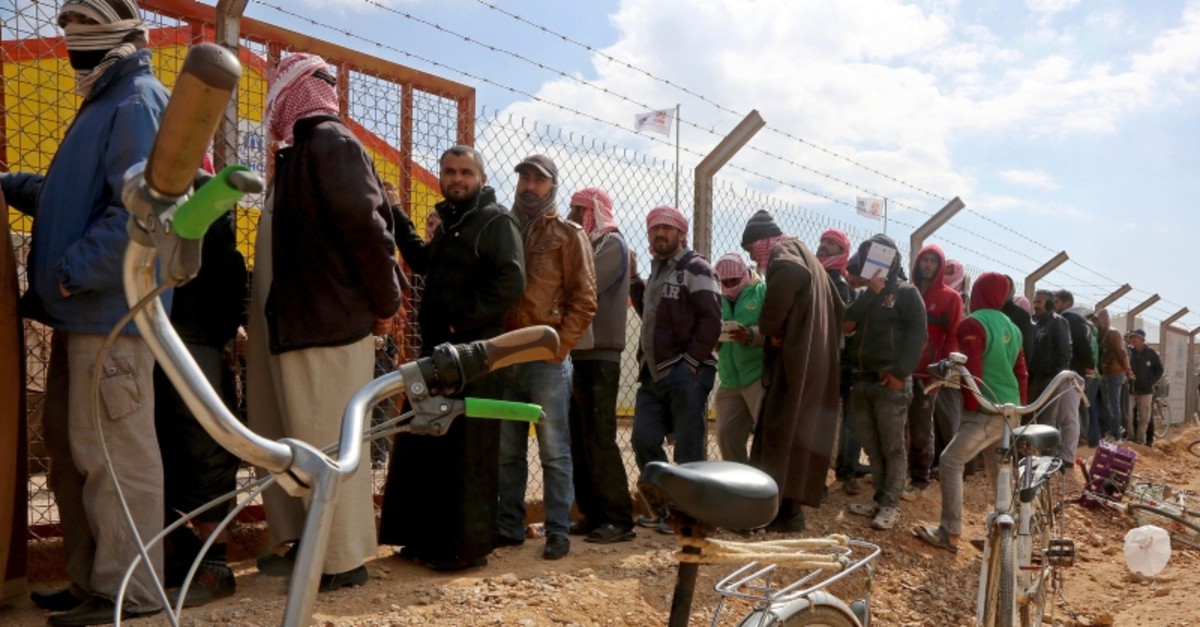 In this Feb. 18, 2018 file photo, Syrian refugees line up to register their names at an employment office, at the Azraq Refugee Camp, 100 kilometers (62 miles) east of Amman, Jordan (AP Photo)