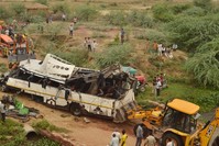 People gather around a damaged bus at the site of an accident where the bus fell into a deep drain on Yamuna Expressway near Agra, Uttar Pradesh, India, 08 July 2019 (EPA Photo)