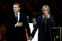 French President-elect Emmanuel Macron holds hands with his wife Brigitte during a victory celebration outside the Louvre museum in Paris, France, May 7.