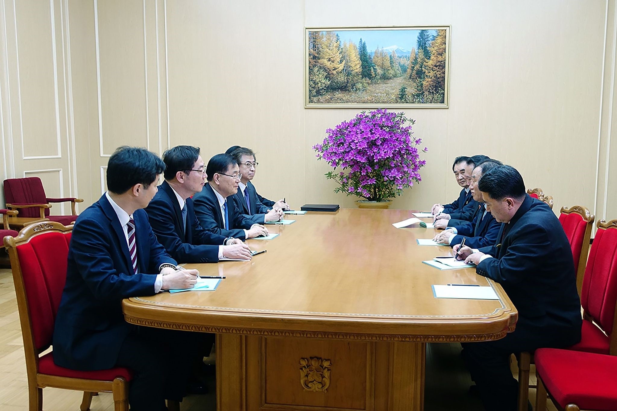 South Korean delegation (L row) talking with General Kim Yong Chol (2nd R), who is in charge of inter-Korean affairs for North Korea's ruling Workers' Party, during their meeting in Pyongyang on March 5, 2018. 