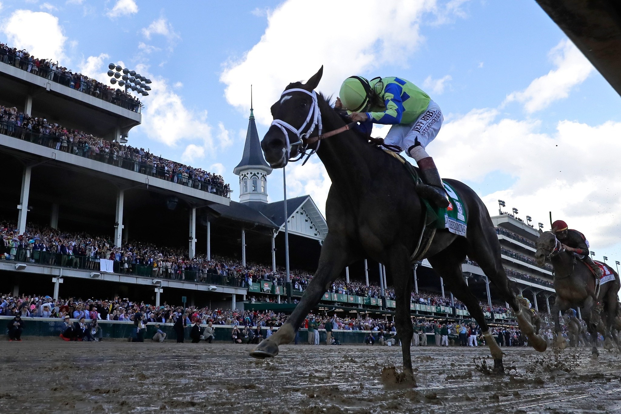 Jockey John Velazquez celebrates as he guides Always Dreaming #5 across the finish line to win the 143rd running of the Kentucky Derby.