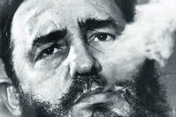 In a file photo  Fidel Castro exhales cigar smoke during a March 1985 interview at his presidential palace in Havana. (AP Photo)