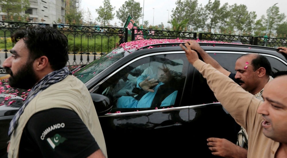 Former Pakistani Prime Minister Nawaz Sharif waves at supporters as his convoy leaves Islamabad, Aug. 9.