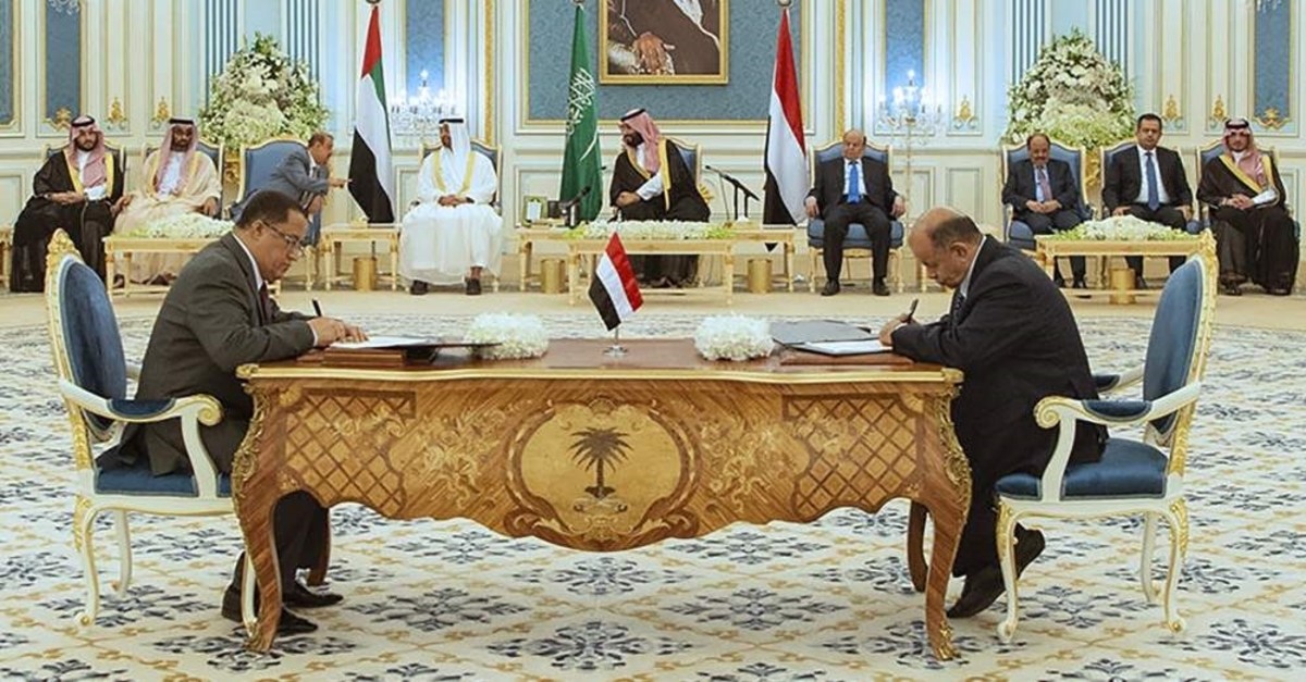 A handout picture provided by the Saudi Royal Palace on November 5, 2019, shows Yemeni Southern Transitional Council (STC) member and former Aden governor Nasser al-Khabji, and Yemen's deputy prime minister Salem al-Khanbashi, sign documents during a peace-signing ceremony