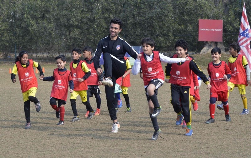 In this picture taken Jan. 6, 2019, Pakistani youths exercise with local coaches at Atletico de Madrid club's new facility for developing football in Lahore, Pakistan. (AFP Photo) 