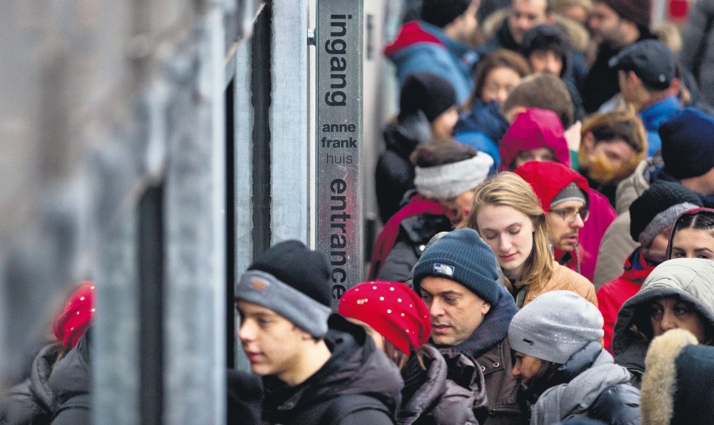 Tourists line up to enter the Anne Frank House in Amsterdam. A record 1,295,585 people visited the Anne Frank House last year, the seventh consecutive year the popular museum broke its visitor record.
