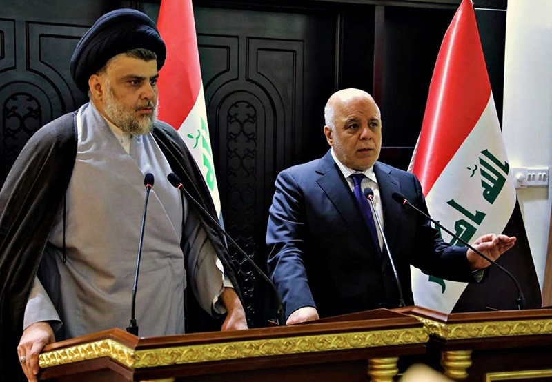 Shiite cleric Muqtada al-Sadr (L) and Iraqi Prime Minister Haider al-Abadi  AP Photo