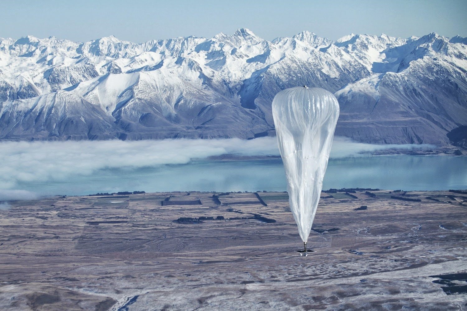 In this June 10, 2013 photo released by Jon Shenk, a Google balloon sails through the air with the Southern Alps mountains in the background, in Tekapo, New Zealand. (AP Photo)