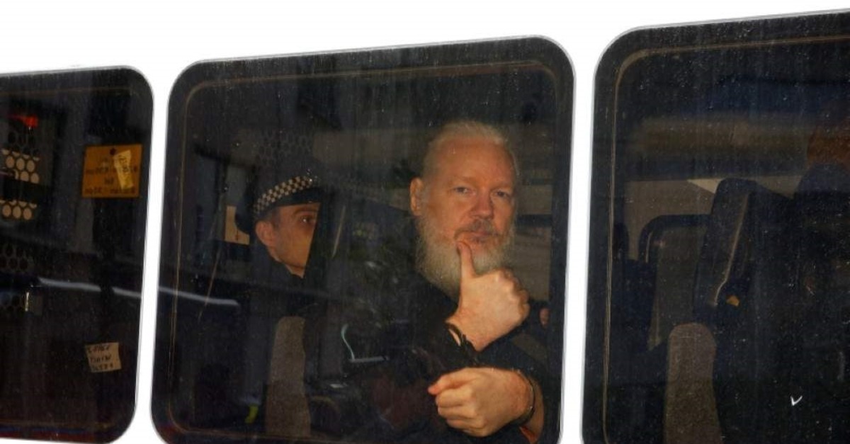WikiLeaks founder Julian Assange is seen in a police van after was arrested by British police outside the Ecuadorian embassy in London, Britain April 11, 2019. (REUTERS Photo)