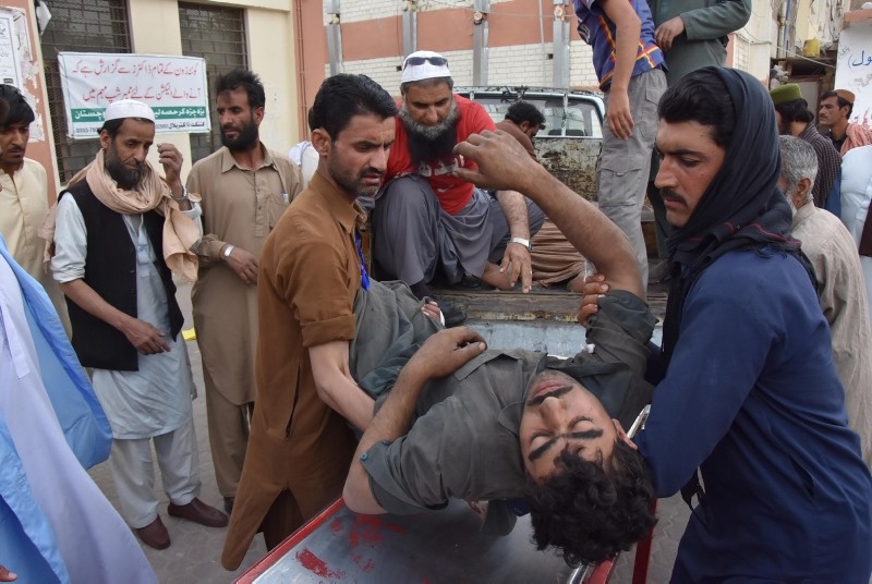 People carry a Coal miner who was injured in a mine explosion to a hospital in Quetta, Pakistan, May 5, 2018