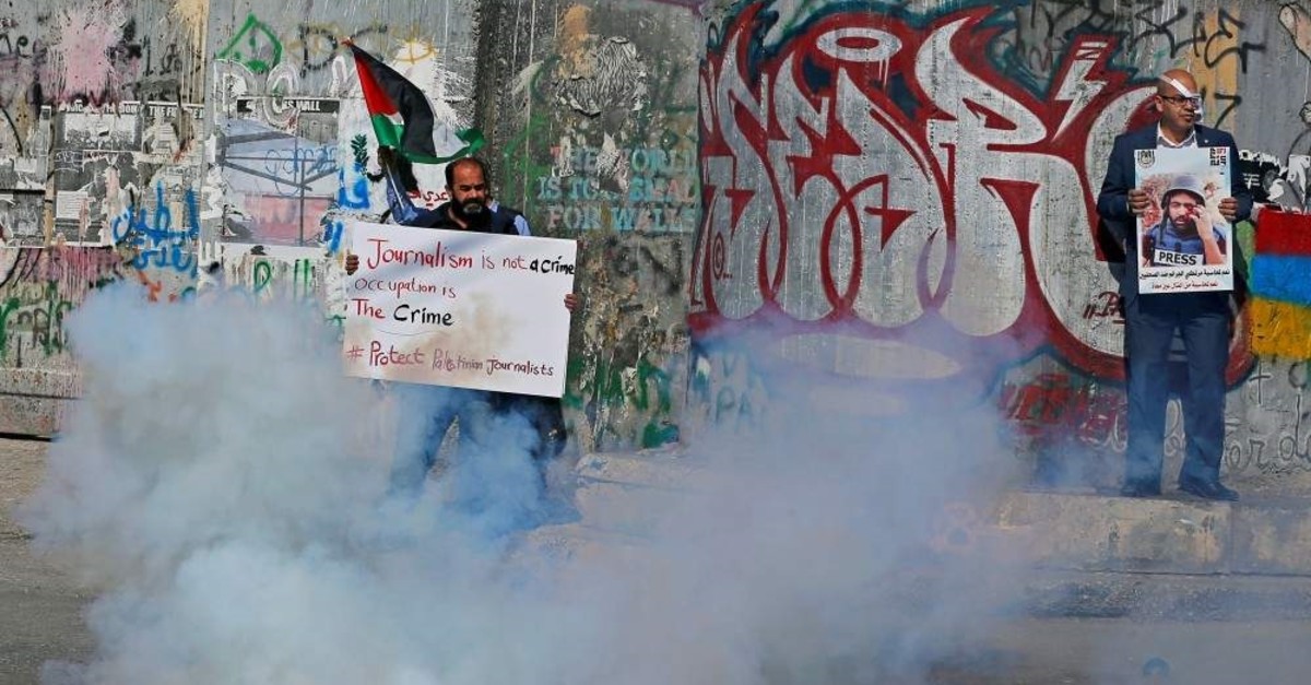 A demonstrator holds a sign during a protest to show solidarity with Palestinian journalists, Bethlehem, Nov. 17, 2019. (Reuters Photo)