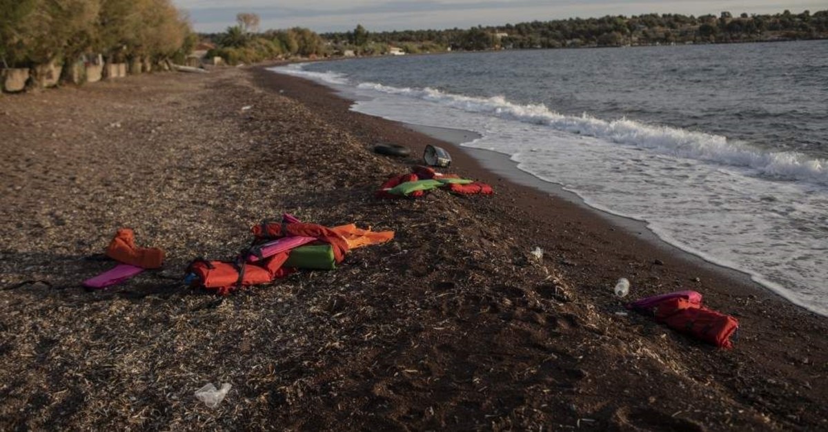 Life vests are seen on a beach at the seaside village of Tsonia, Lesbos island, Greece after the arrival of refugees and migrants on a rubber boat from Turkey, Oct. 7, 2019. (AP Photo / Petros Giannakouris)