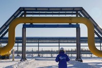 An employee in branded jacket walks past a part of Gazprom's Power Of Siberia gas pipeline at the Atamanskaya compressor station outside the far eastern town of Svobodny, Amur region, Russia, Nov. 29, 2019. (Reuters Photo)