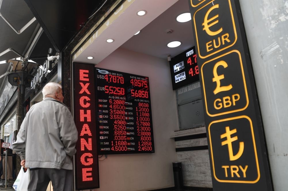 A man looks at a board displaying U.S. dollar and euro exchange rates in Turkish lira at an exchange office, Istanbul, May 23.