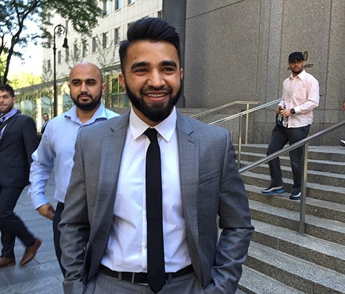 New York Police Department Officer Masood Syed, a practicing Muslim, center, smiles as he leaves Manhattan federal court in New York Wednesday, June 22, 2016 (AP Photo)	