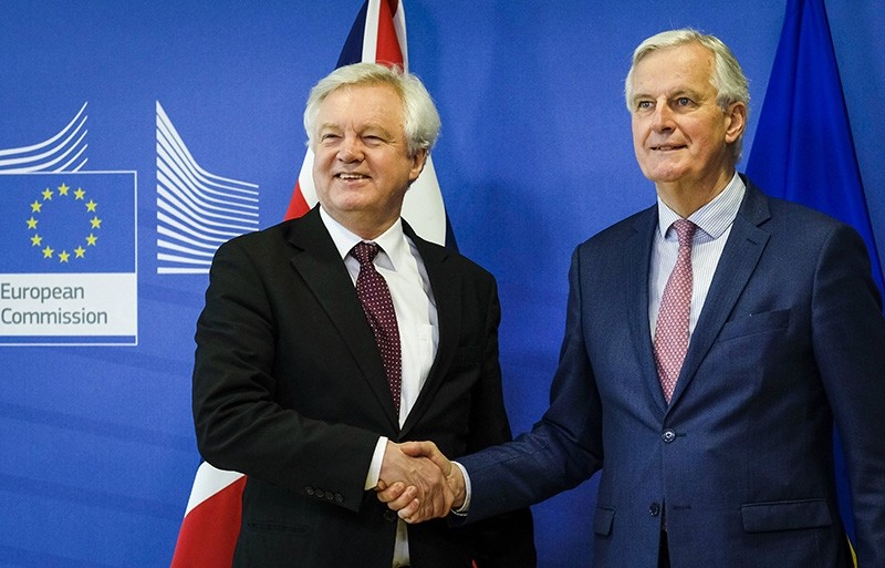 Britain's Secretary of State for Exiting the European Union David Davis and European Union's chief Brexit negotiator Michel Barnier pose ahead of a meeting in Brussels, Belgium, March 19, 2018.  (Reuters Photo)