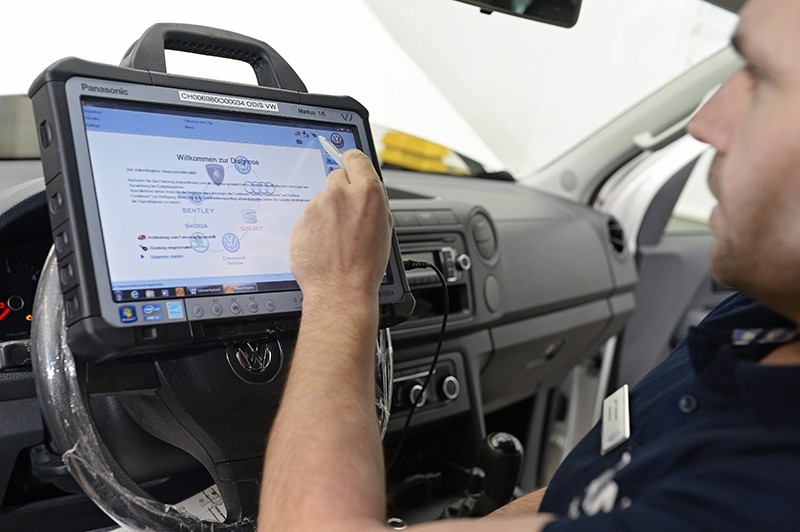 Chief mechanic Ueli Portmann loads a software update into a EA189 diesel engine of a Volkswagen (VW) Amarok car after recalling many vehicles following the VW exhaust emissions scandal (EPA File Photo)