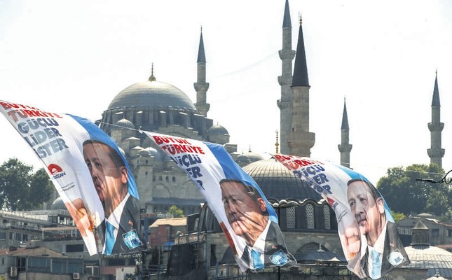 Election posters of President Recep Tayyip Erdoğan and his ruling Justice and Development Party (AK Party) decorate a street in İstanbul, June 6.