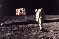The famous photo of Neil Armstrong landing on the moon and erecting the American flag. 