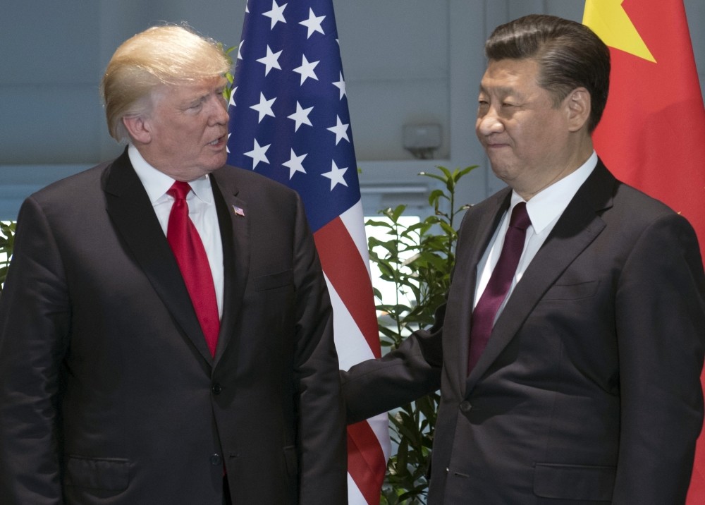 The President Trump (L) and Chinese President Xi arrive for a meeting on the sidelines of the G20 Summit in Hamburg, July 8.