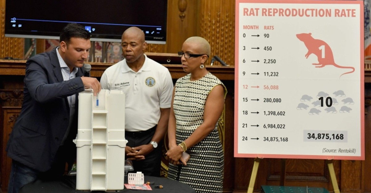 President of Rat Trap Inc., Anthony Giaquinto (L) joins Brooklyn Borough President Eric. L. Adams  (C) as he announces the results of a pilot program aimed at curbing the rat population around Brooklyn (AFP Photo)