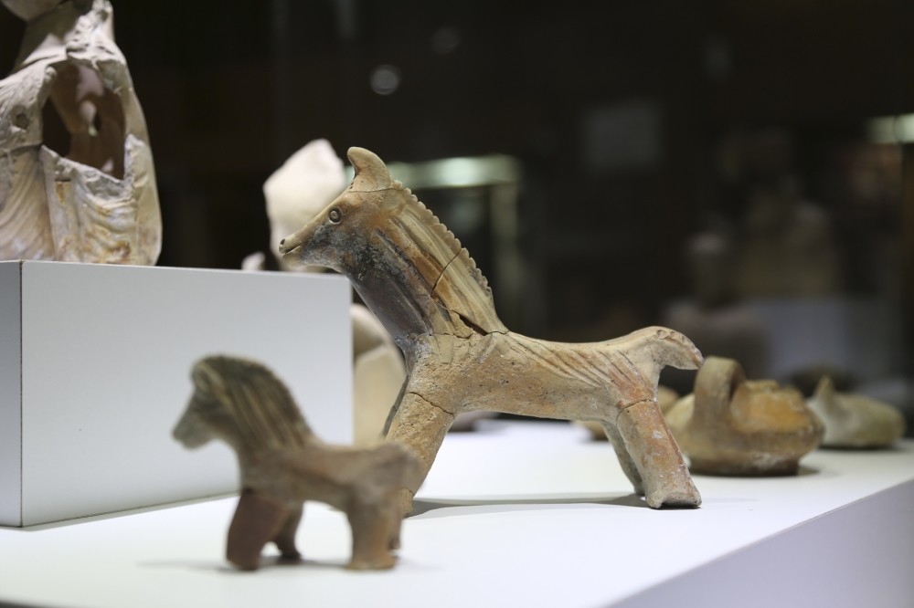 Four small horse figures made of terra-cotta are believed to be gifts left at the graves of those who have passed away at an early age.