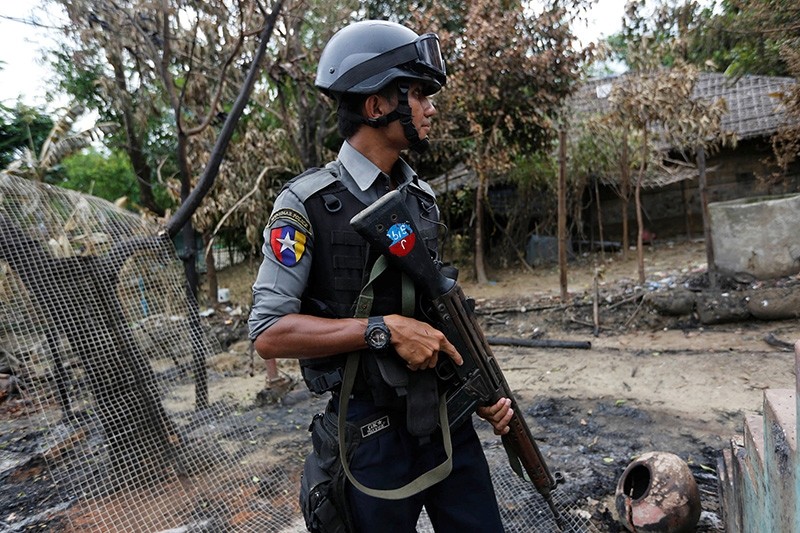 A police officer guards near a house which was burnt down during the last days of violence in Maungdaw, northern Rakhine State, Myanmar Aug. 30, 2017. (Reuters Photo)