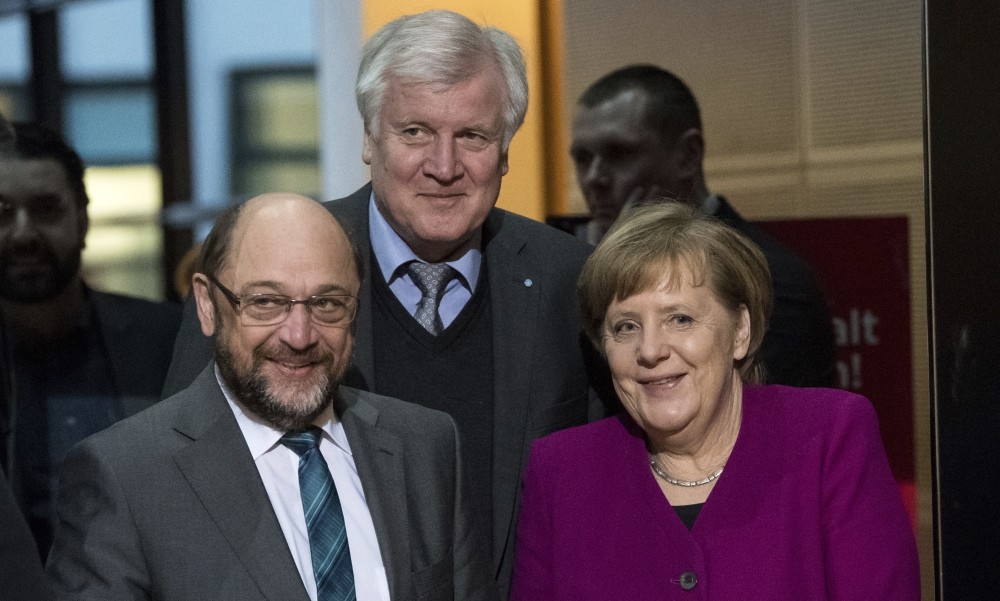 SPD leader Schulz (L), CSU leader Horst Seehofer (C) and CDU leader Chancellor Merkel arrive for coalition negotiations to form a government, Berlin, Feb. 2.