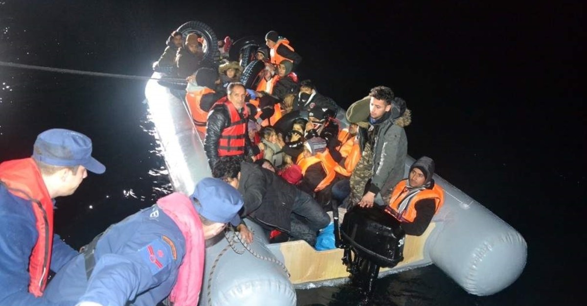 Turkish Coast Guard Command officers pull a group of illegal migrants to their boat, Bal?kesir, Dec. 29, 2019. (AA Photo)