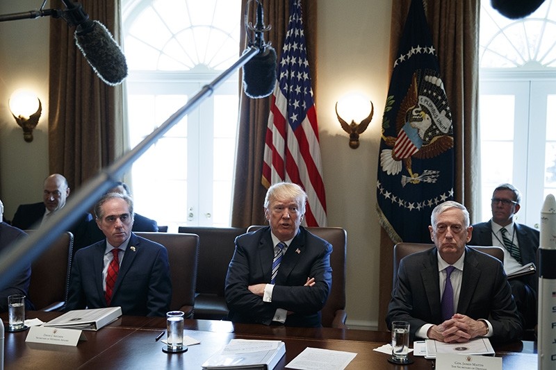 Secretary of Veterans Affairs David Shulkin, left, and Secretary of Defense Jim Mattis, right, listen as President Donald Trump speaks during a cabinet meeting at the White House, Thursday, March 8, 2018, in Washington. (AP Photo)