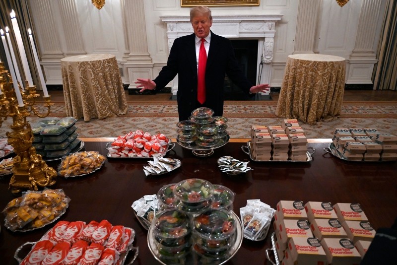 President Donald Trump talks to the media about the table full of fast food in the State Dining Room of the White House in Washington, Monday, Jan. 14, 2019 (AP Photo)