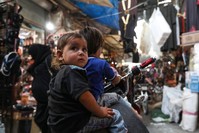 Syrian children sit on a motorcycle at a market in the opposition-held Idlib province, Sept. 27.